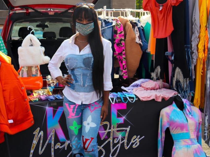 Liberal Arts alumna Khadesia "Keke" Walker stands in front of her Keke Mary Styles table during a pop-up shop event. 