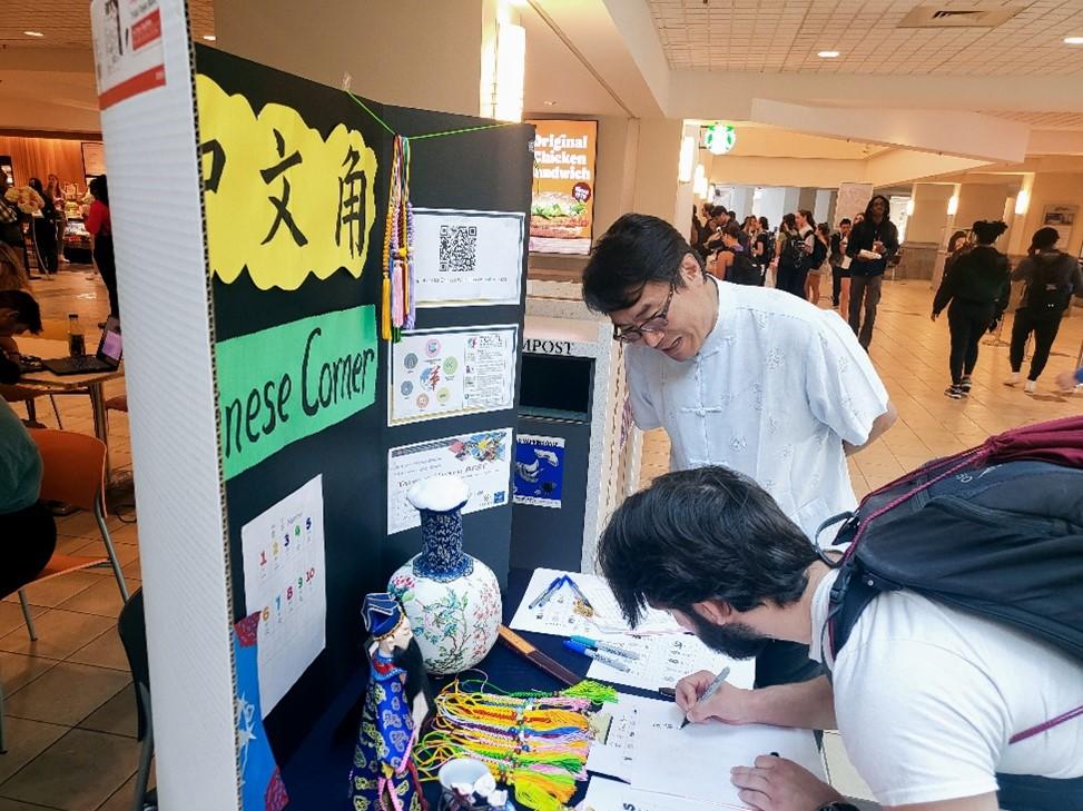Two people reviewing a poster presentation