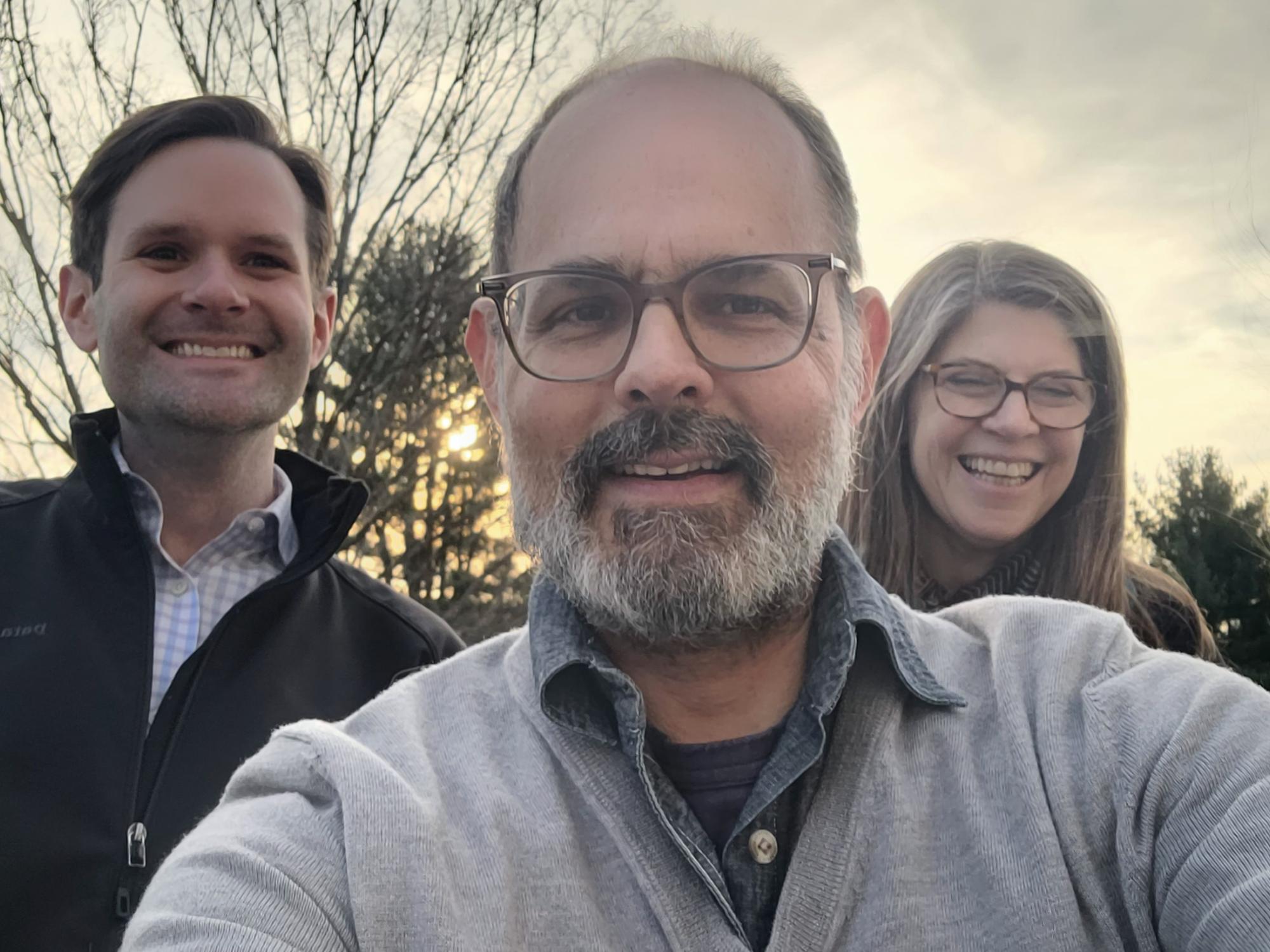 Joseph Polizzi takes selfie with former co-workers at Sacred Heart University.