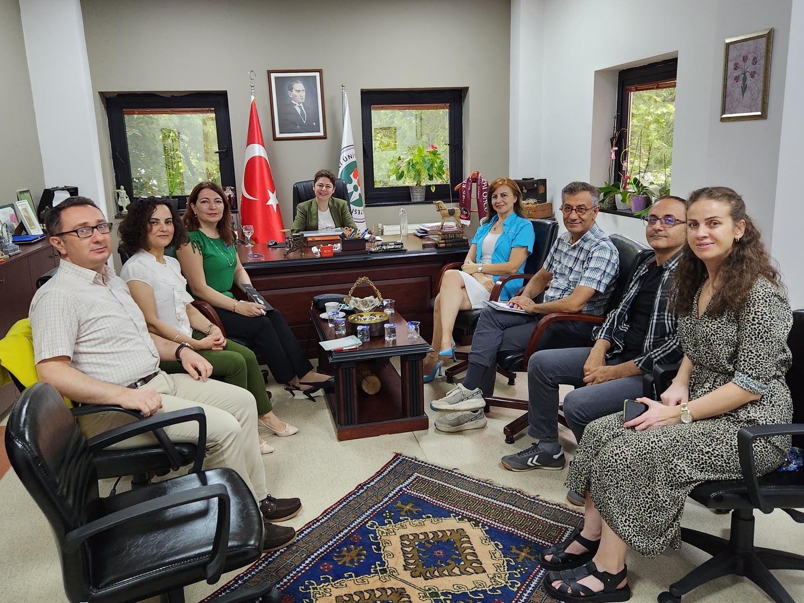 Poyrazli and several male and female colleagues seated in an office