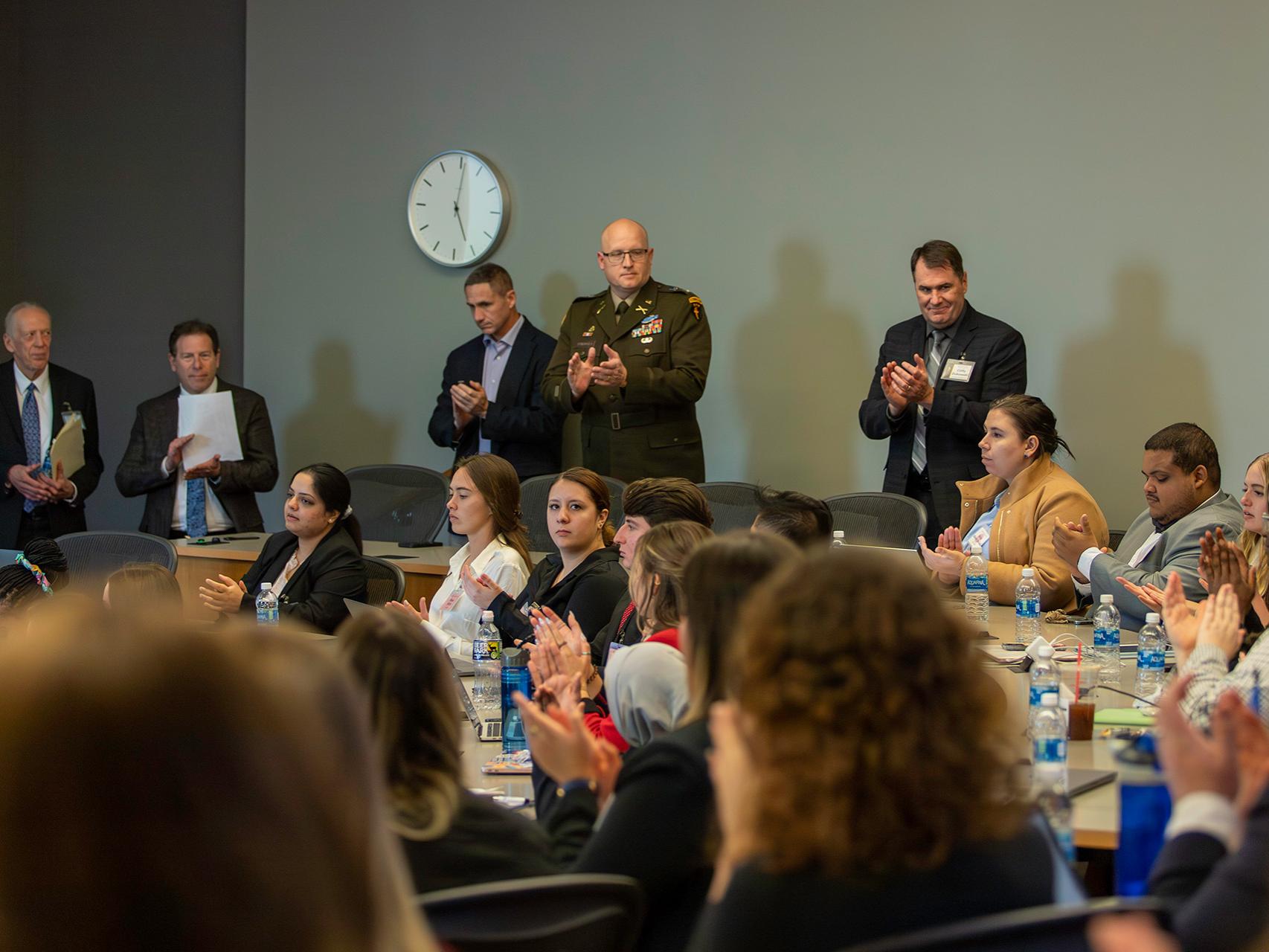 The international crisis simulation was led by SIA Professor Amb. Dennis Jett (top row, far left), SIA Director Dr. Mitchell Smith (second from left), and USAWC ISCNE Program Director Cliffy Zukowski (far right).