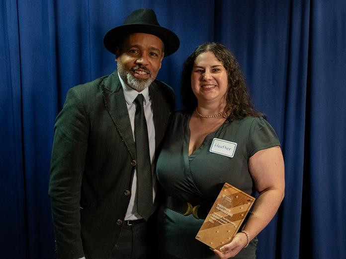 Women receives award from man