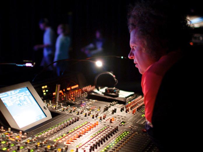 Man at a mixing board for a theatre production