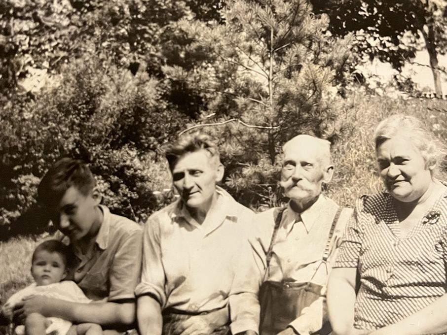 A family photograph of a baby and four adults