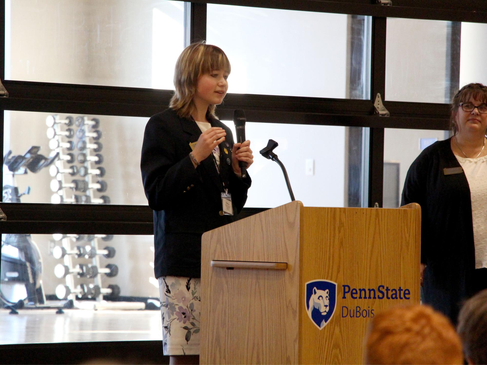 Madigan McGrath, Ridgway student and District 1 representative for Pennsylvania DECA, offers her welcome message at the start of district’s annual conference, held at Penn State DuBois.