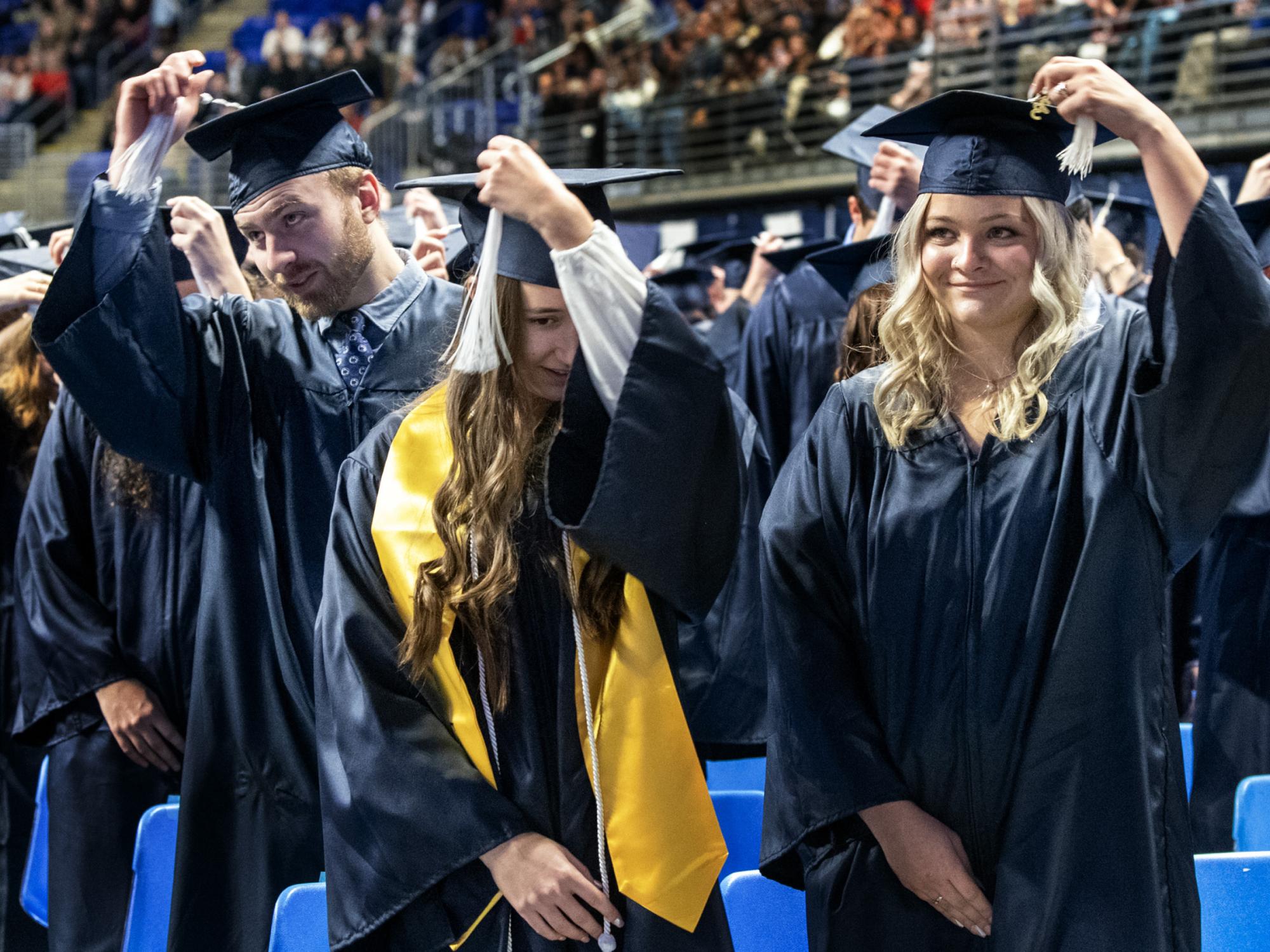 graduates turn tassels