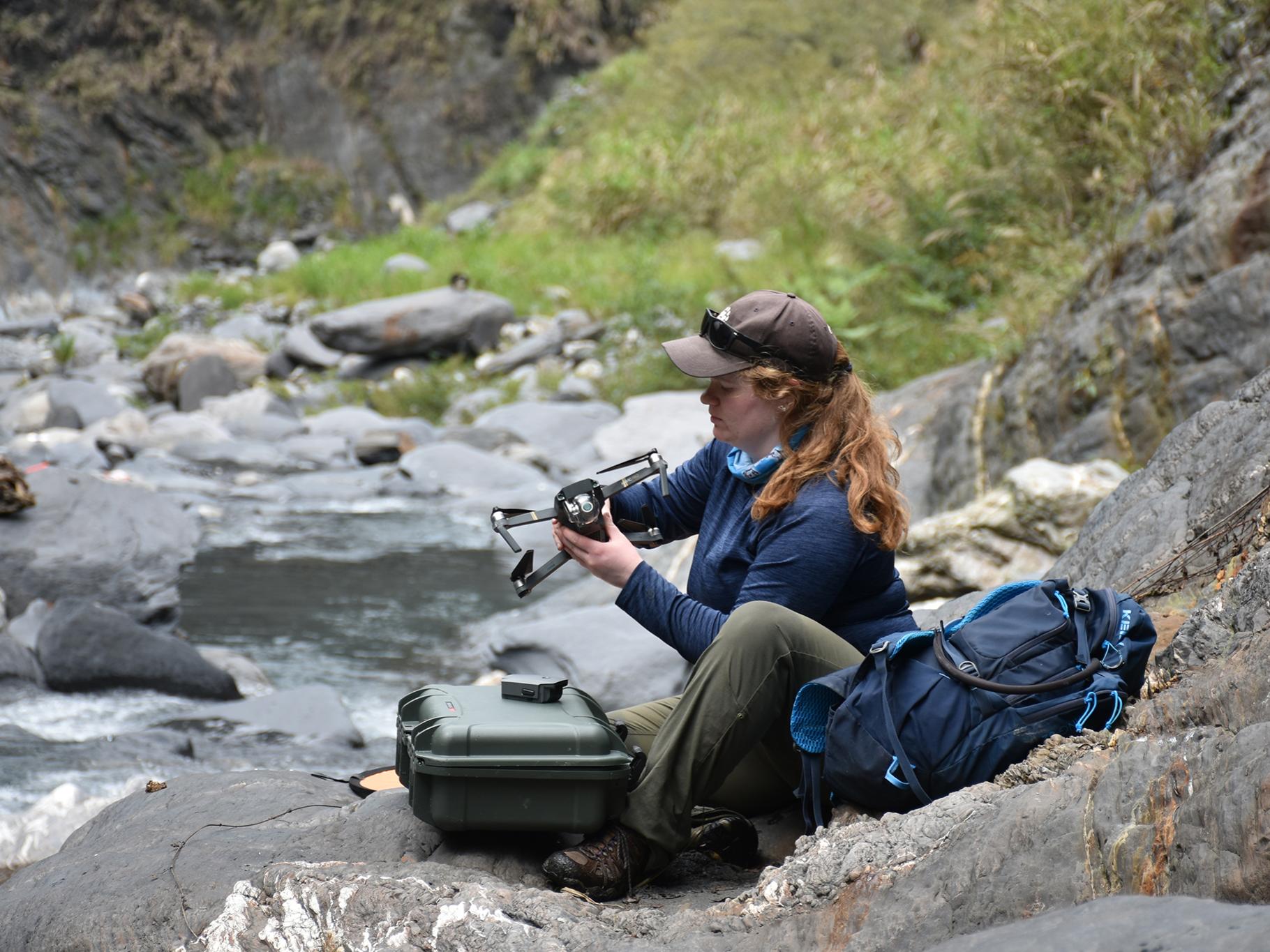 Julia Carr, former doctoral student at Penn State, prepares a drone to survey a section of river channel in central Taiwan