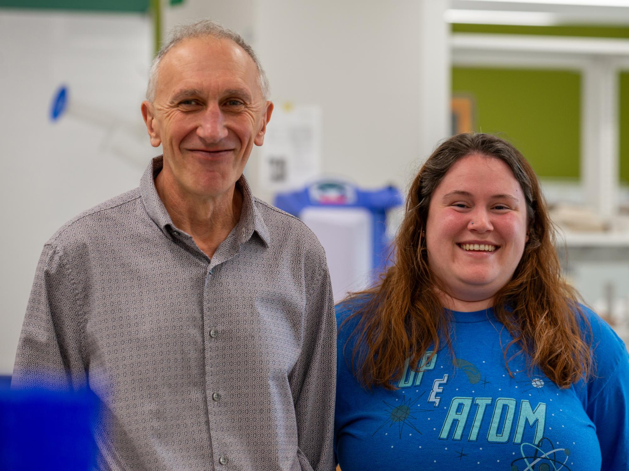 Two individuals stand in a lab.