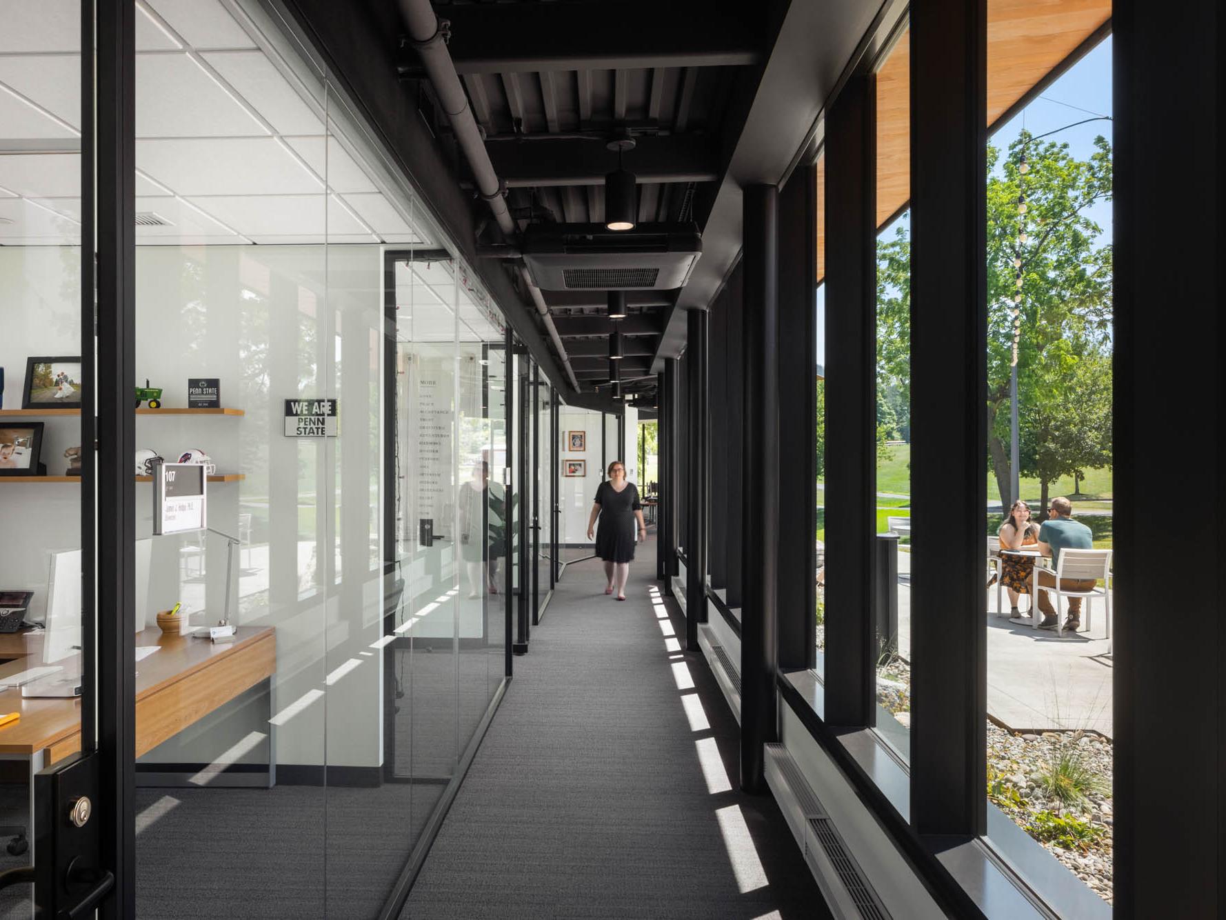 A glass-walled hallway at Penn State Behrend's Federal House