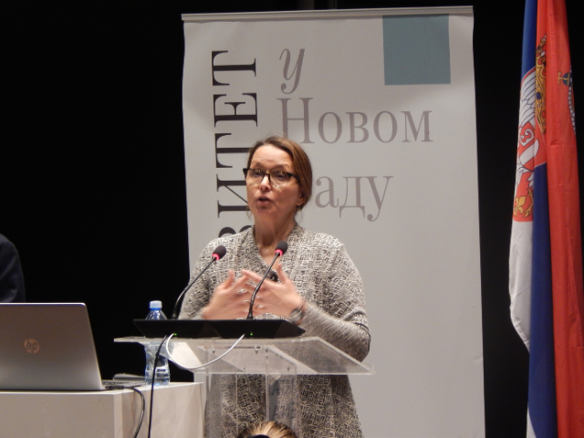 A woman standing behind a podium