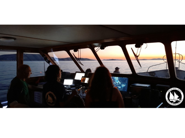 students explore the waters of Greece inside a boat