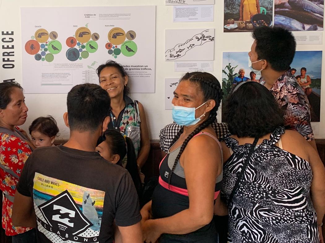 Residents of Iquitos view the “Tres Comunidades, Un Río” exhibition at the opening ceremony in Iquitos, Peru. 