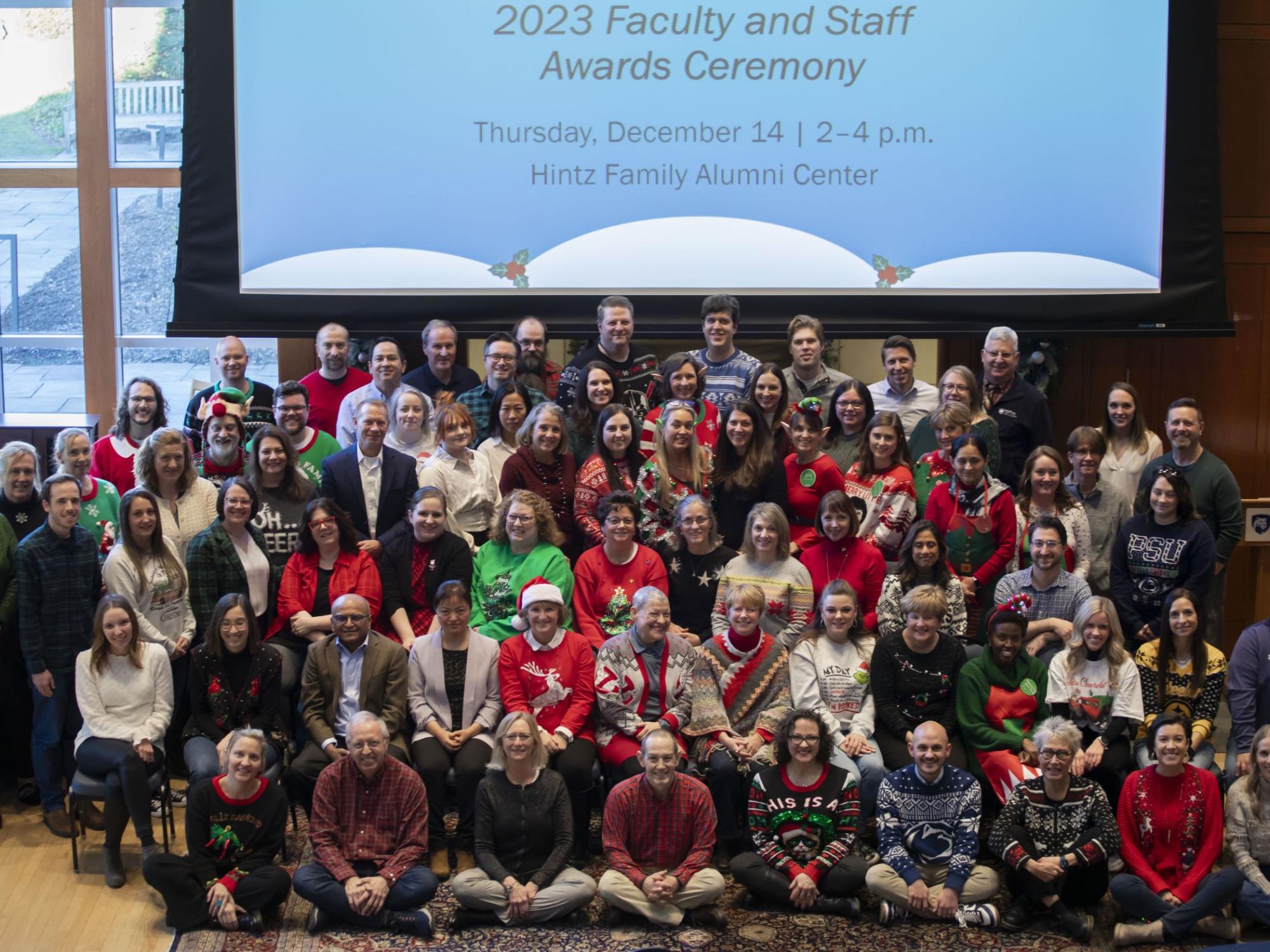 large group of people in casual and holiday attire gathered for ceremony 
