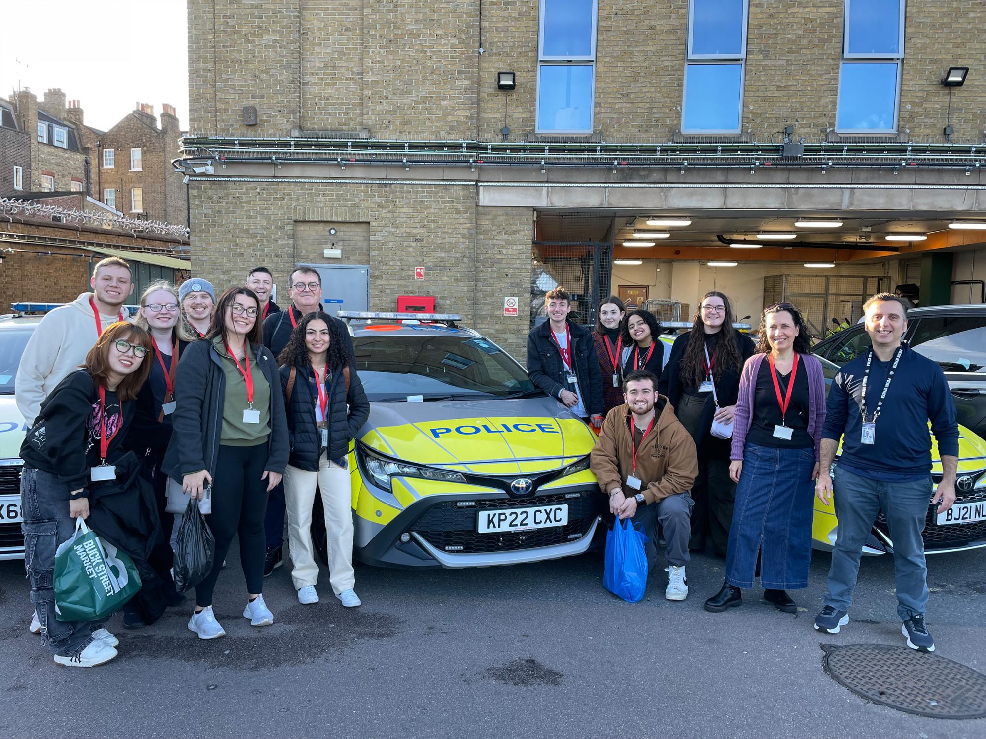 Students of the course CRIMJ 499 Serial Killers and European Criminal Justice next to a London police vehicle.