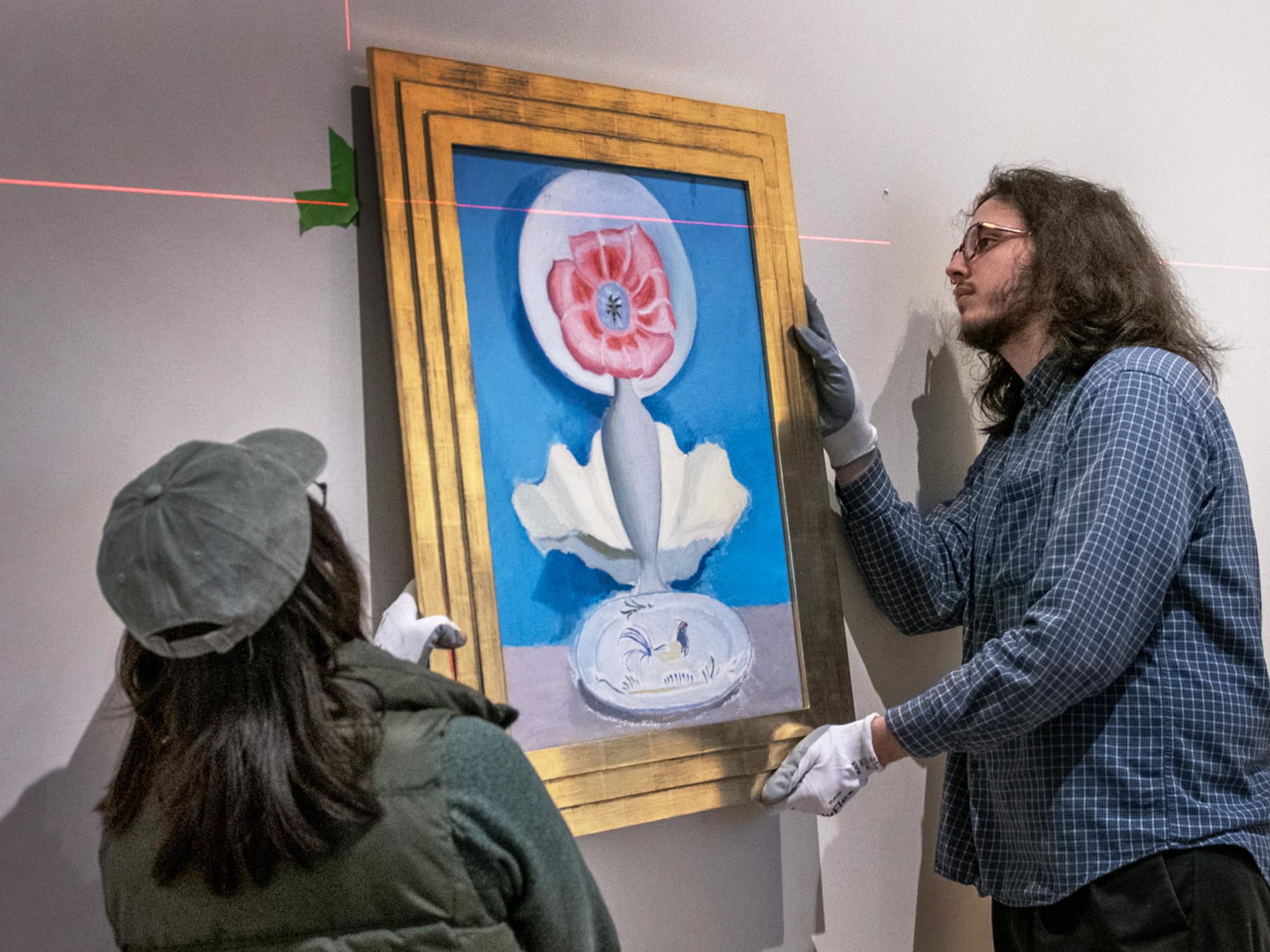 hanging painting at Palmer Museum of Art