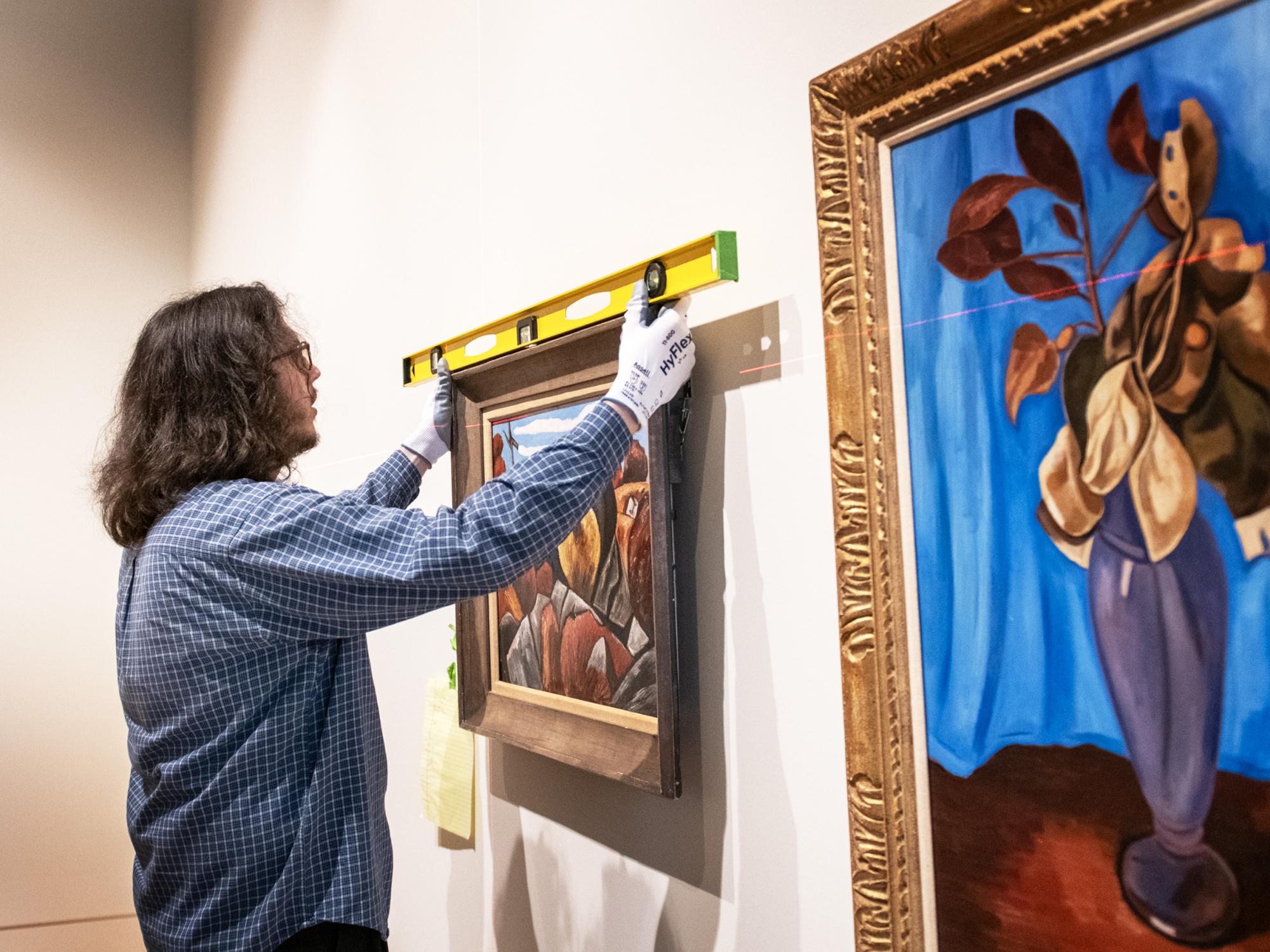 checking paintings on display for level