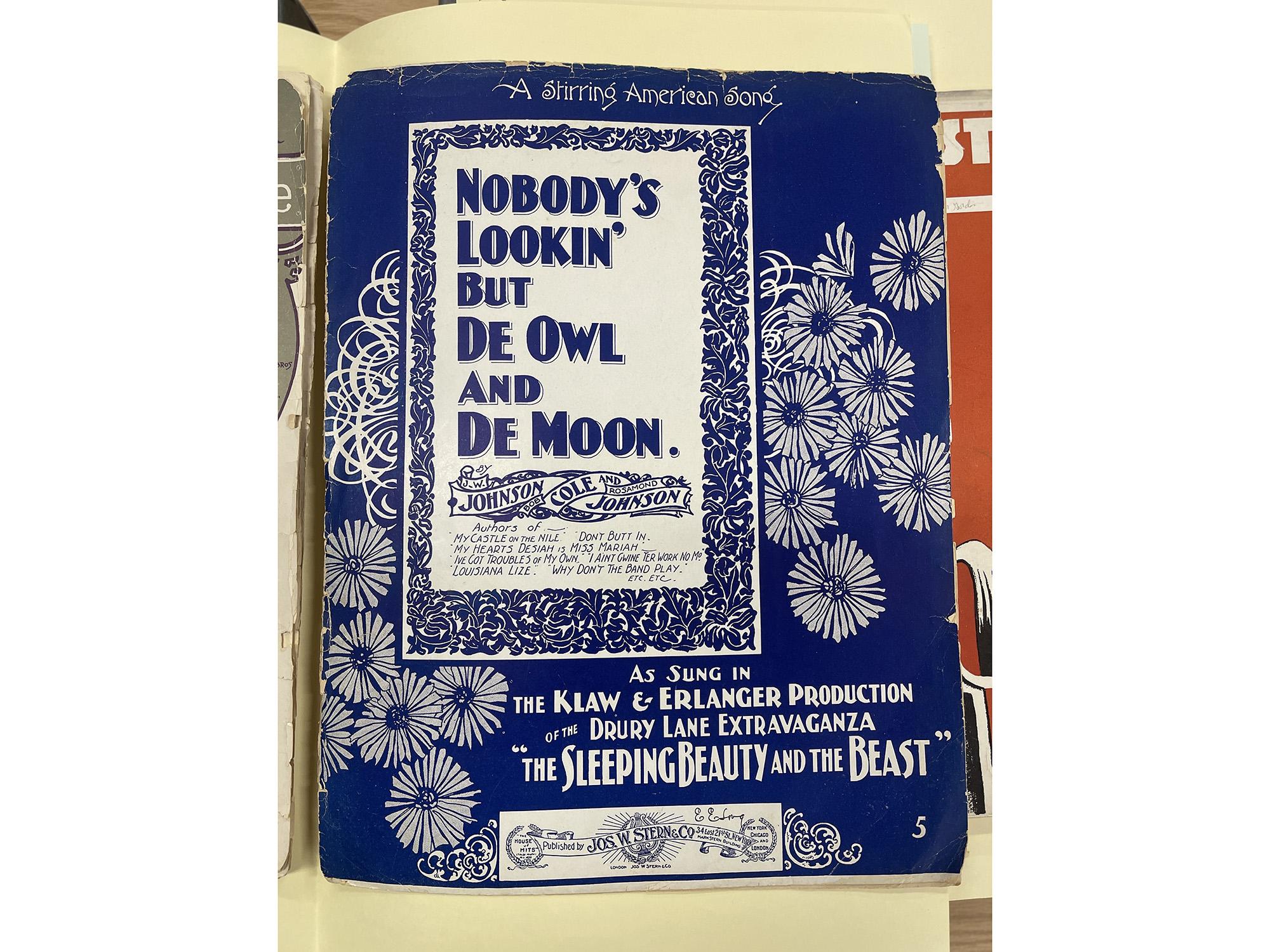 Historical sheet music with a blue cover and floral detailing