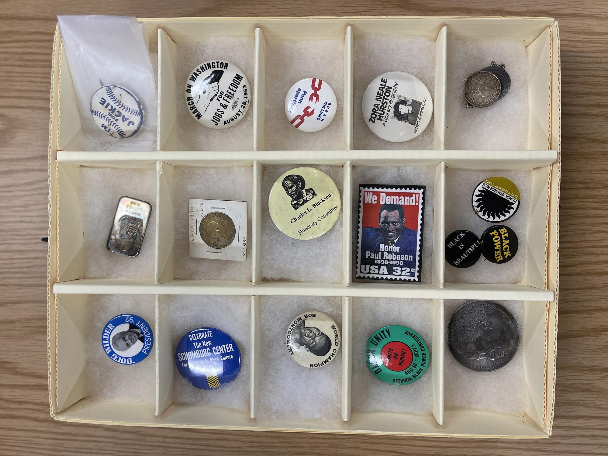 A collection of pins related to civil rights and Black historical figures.