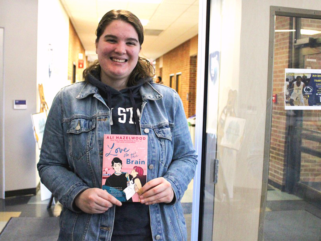 Student Chloe Tucker shows off her book, love on the brain.