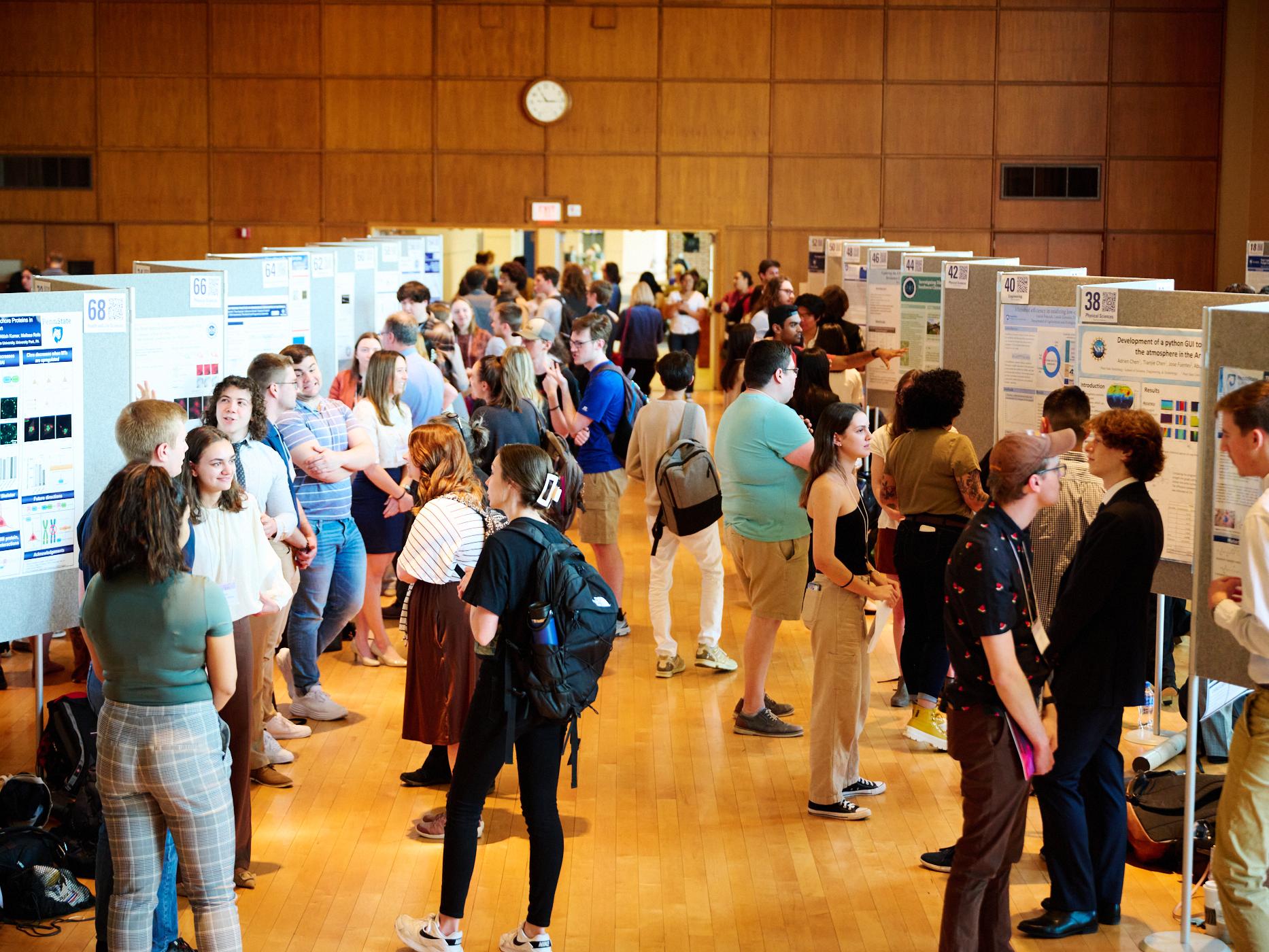 Photo of student presenters in 2023 Undergraduate Exhibition in Alumni Hall