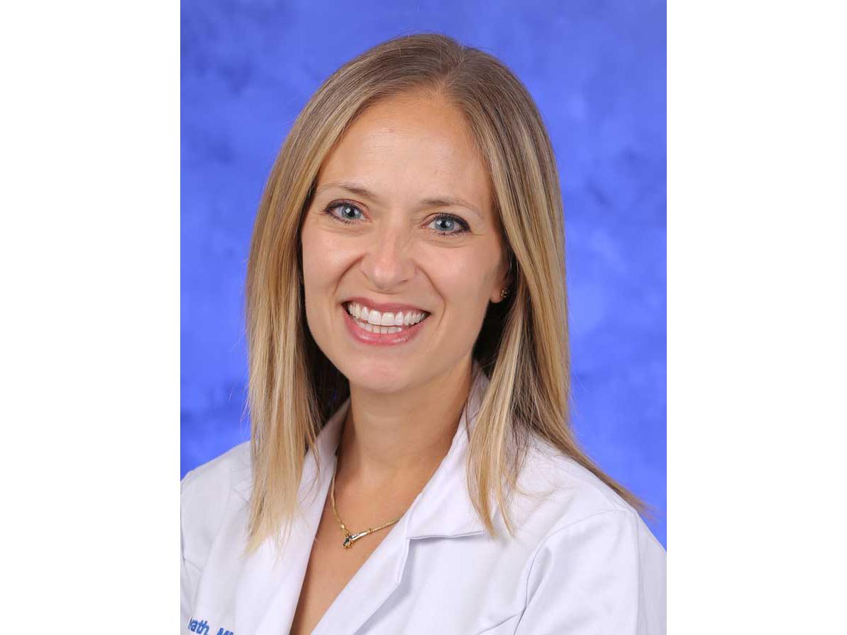A portrait of Sarah Horvath in a white coat from the shoulders up. 