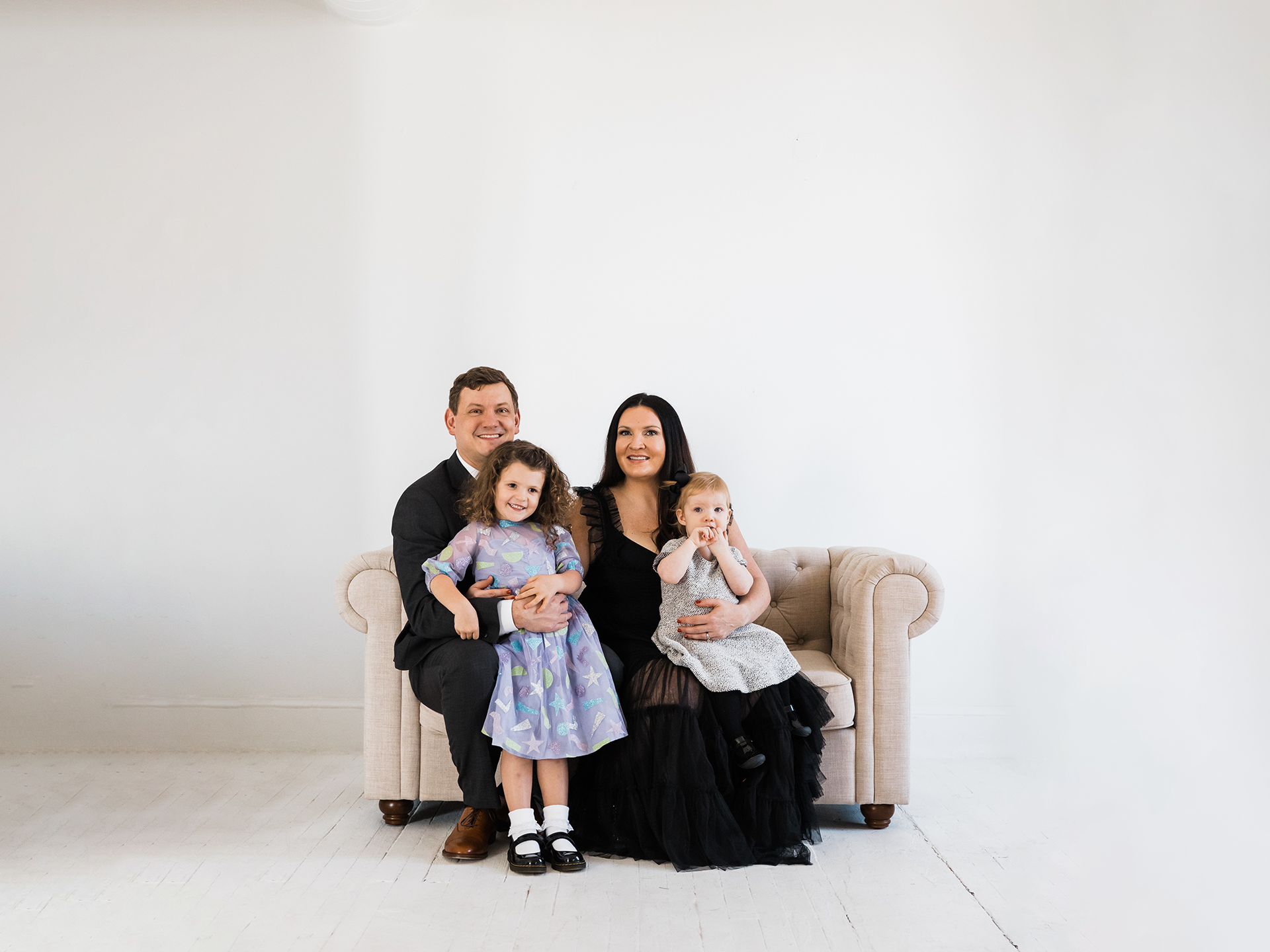 formal family portrait parents and two children