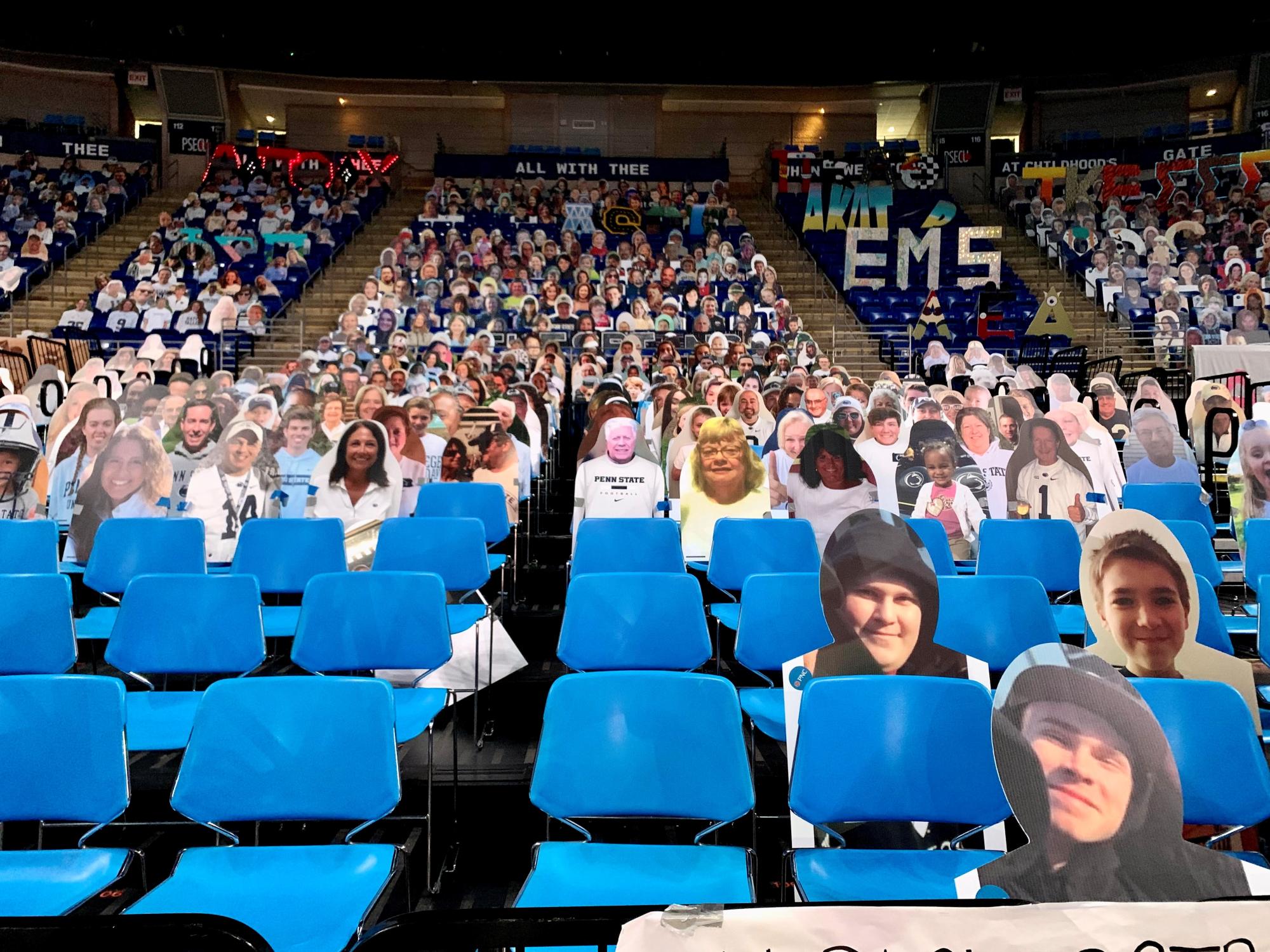 Cardboard cutouts of supporters' faces fill the stands