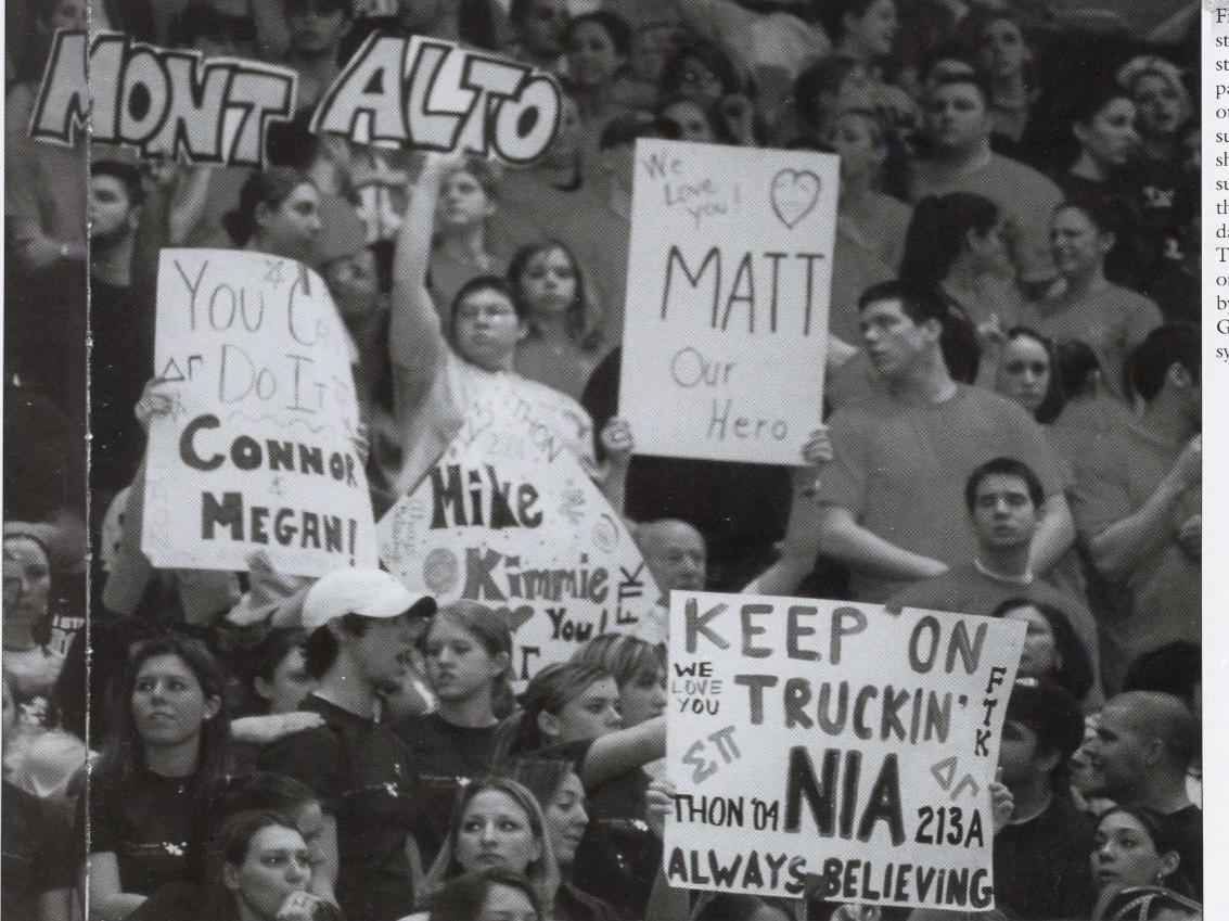 A shot of supporters holding signs in the stands at THON 2004