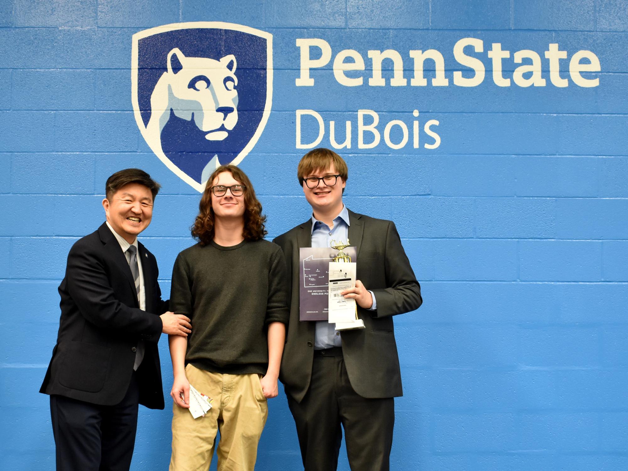 Individual award winners Henry May, middle, and Connor Siple, right, are recognized by Jungwoo Ryoo, chancellor and chief academic officer at Penn State DuBois, for their accomplishments during the Senior Scholastic Challenge, held at Penn State DuBois.