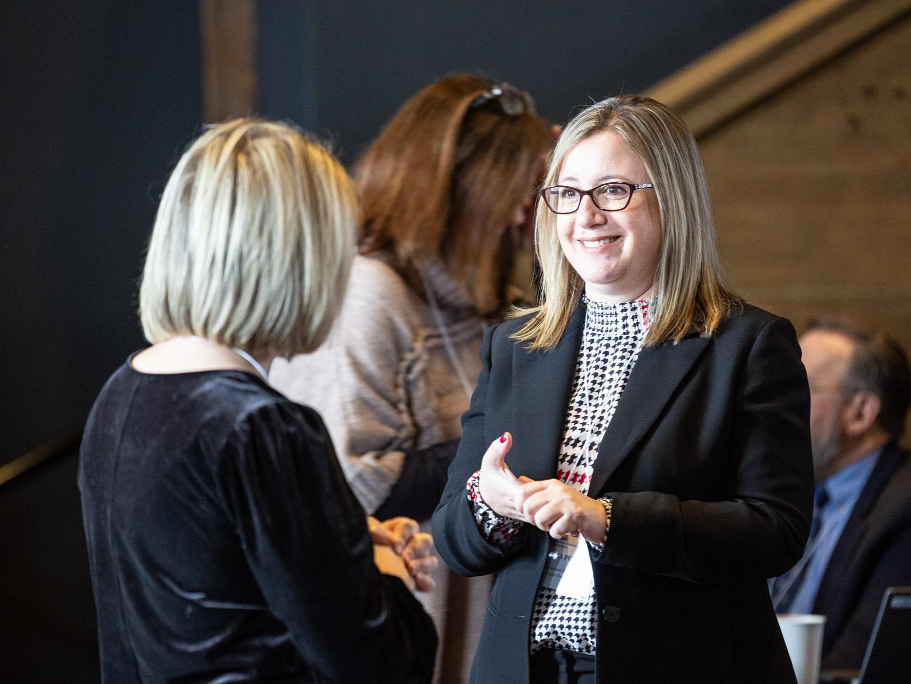 Jess Petrie, CTSI's Education Project Manager, speaks with other CTSI staff.