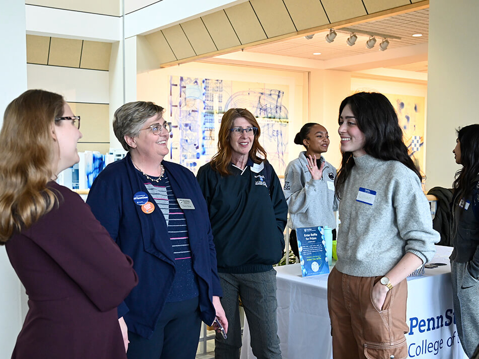 Patty Klug (second from left) and Michelle Powers (third from left) interact with a student at the Liberal Arts First-Gen Mixer held in March of 2023.