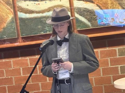 Student Emma Moniz reads an original poem.