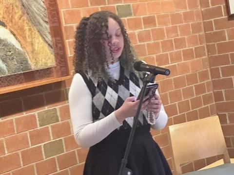 Student Emera Gregor reads from an original short story.