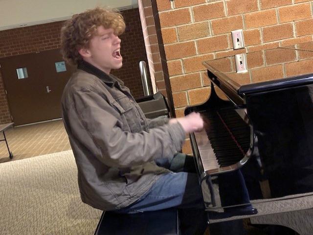 Levi Custer performs a song on piano.