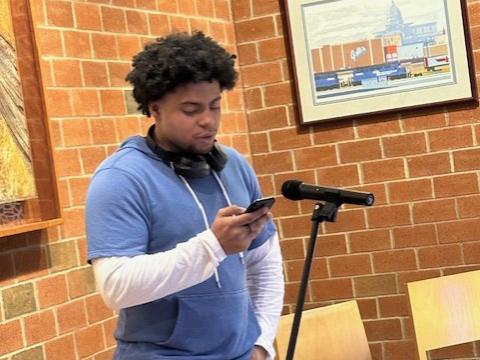 Student Ishmael Bruney reads an original poem.