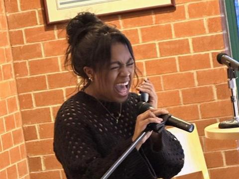 Liz Green performs the song "At Last." 