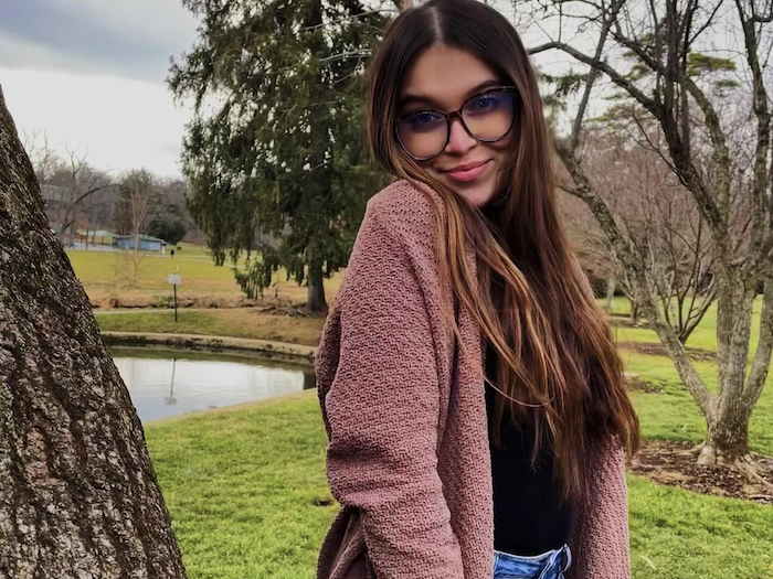 Portrait of Meagan McGlone outside next to a tree