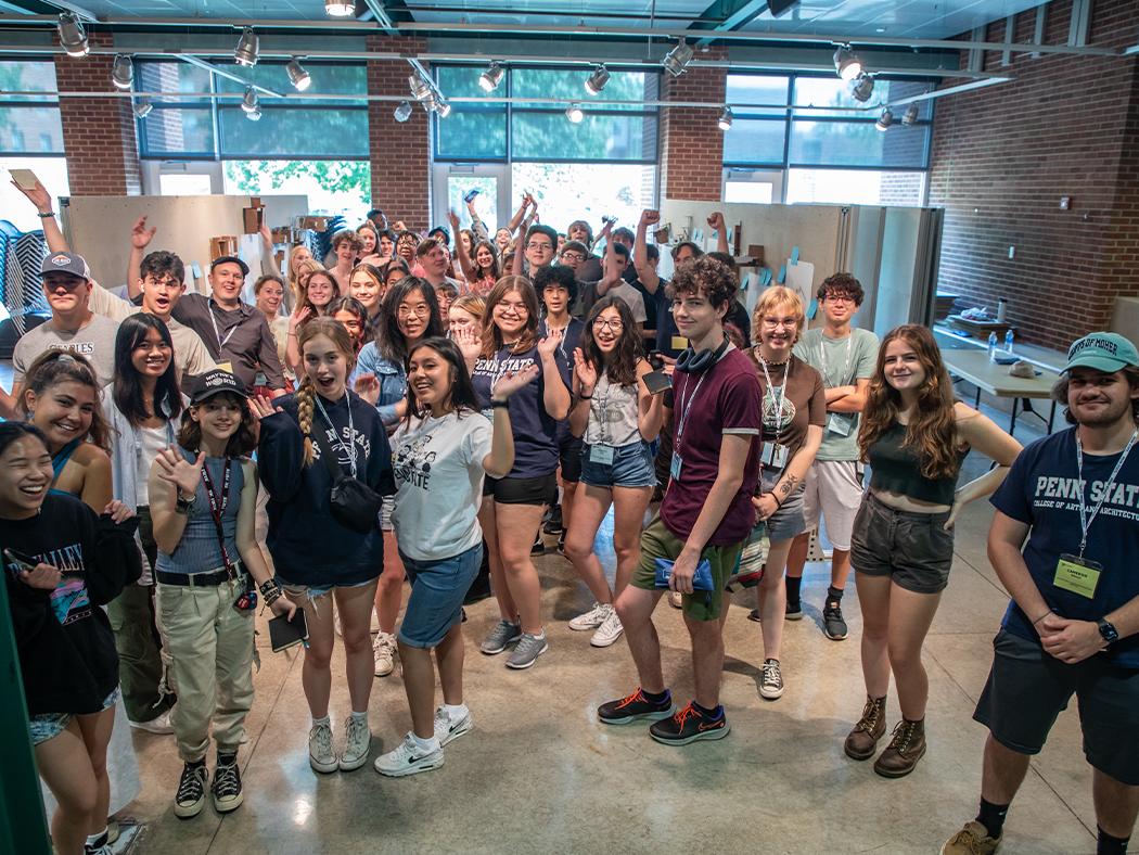 A group of Architecture and Landscape Architecture Summer Camp participants celebrate in the Stuckeman Family Building Jury Space.
