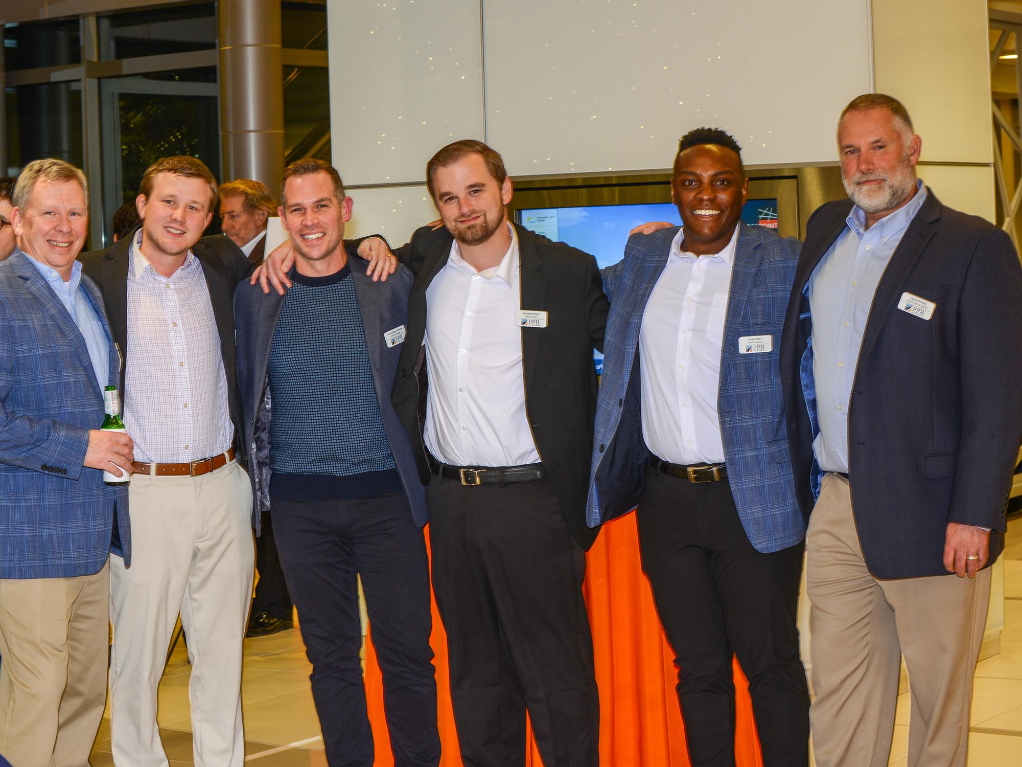 Second from the left, Taylor Nelson poses with five other PPR employees.