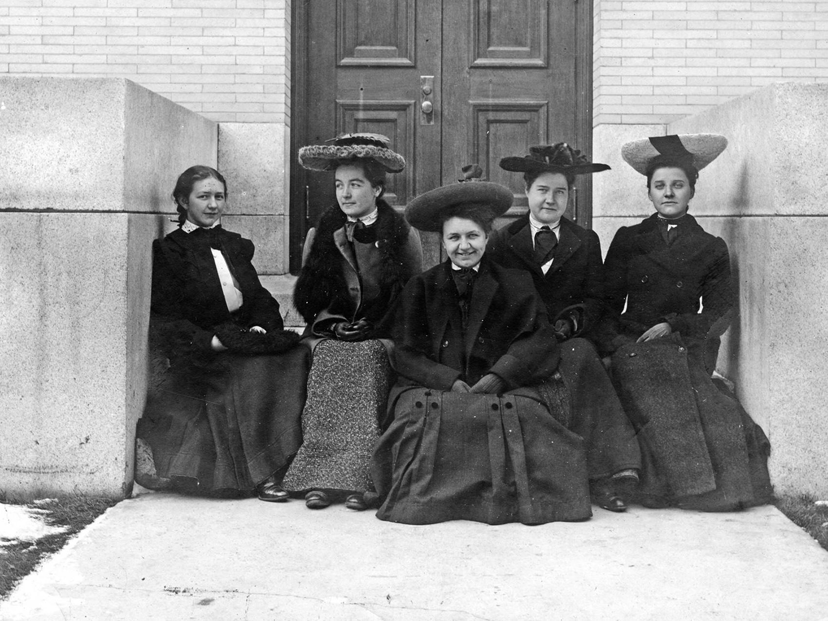 A group of five women, four of them wearing hats, in 1905