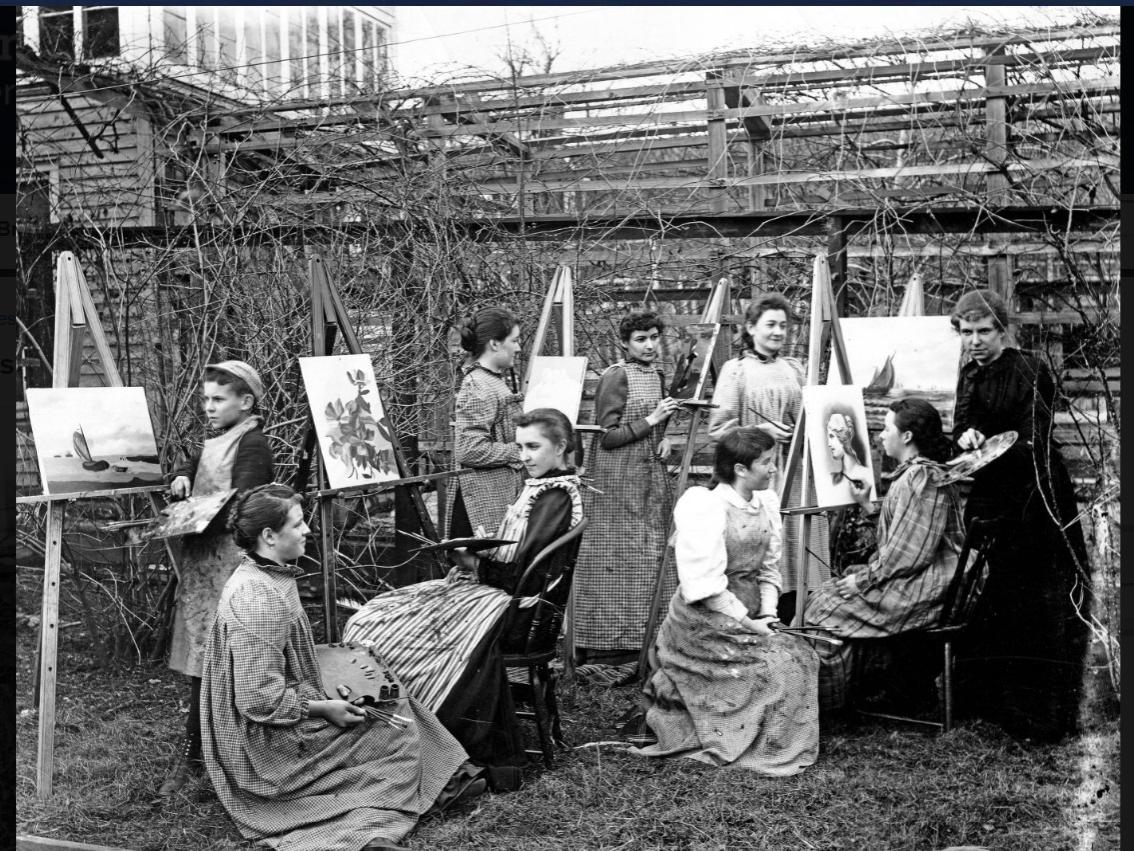 A black and white picture of female students painting on easels