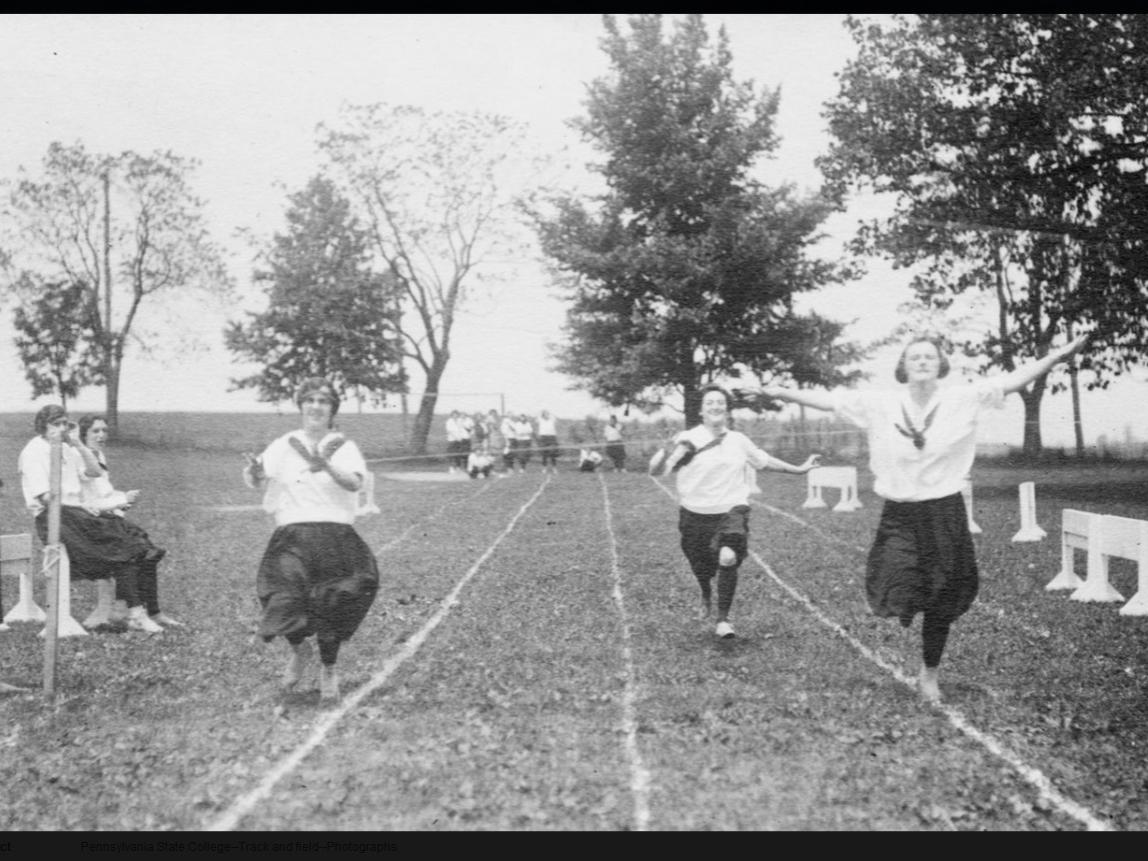 Three women approach the finish line of a foot race in 1922