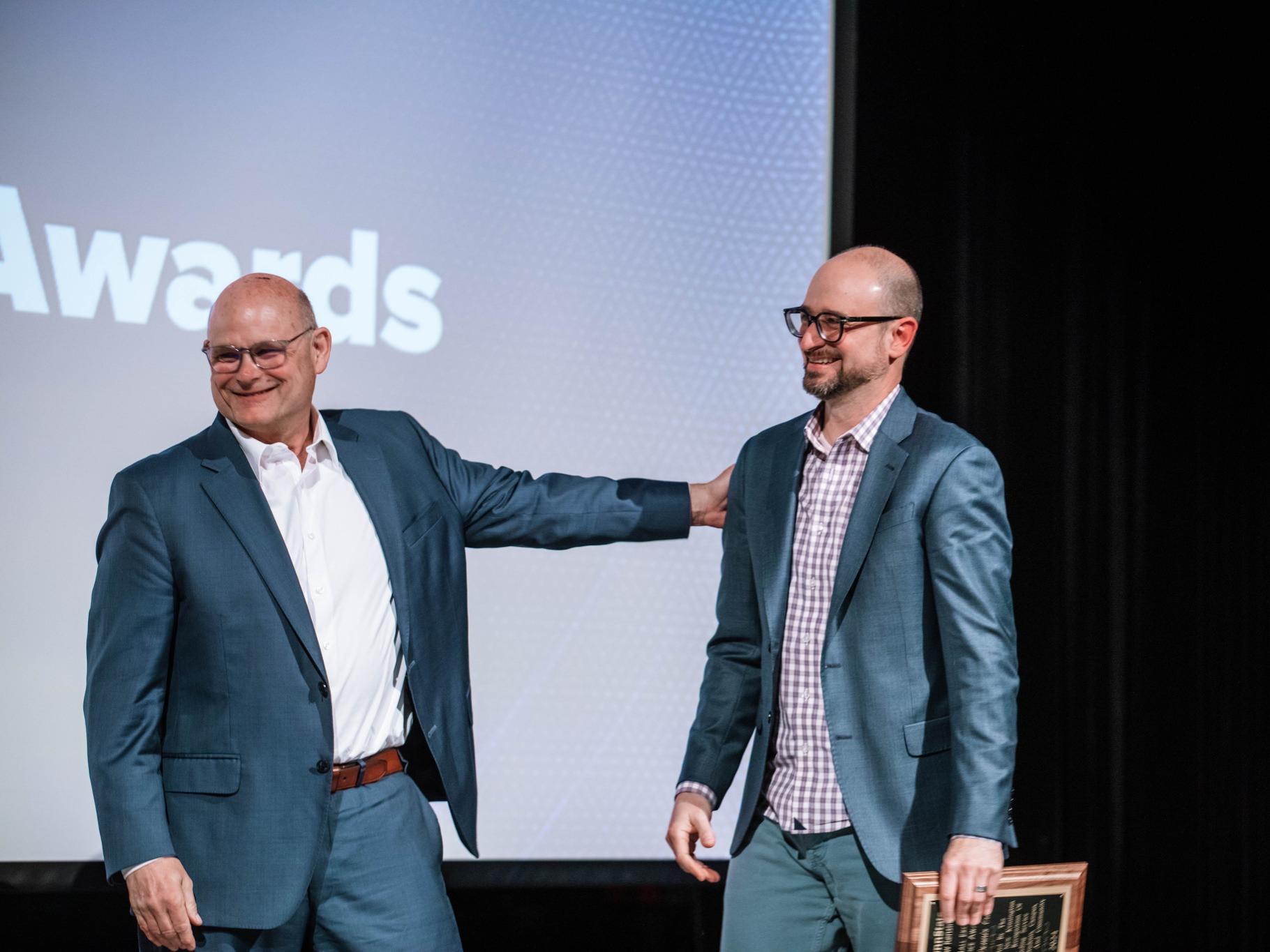 Kevin Snider and Joe Cuiffi laughing during awards ceremony
