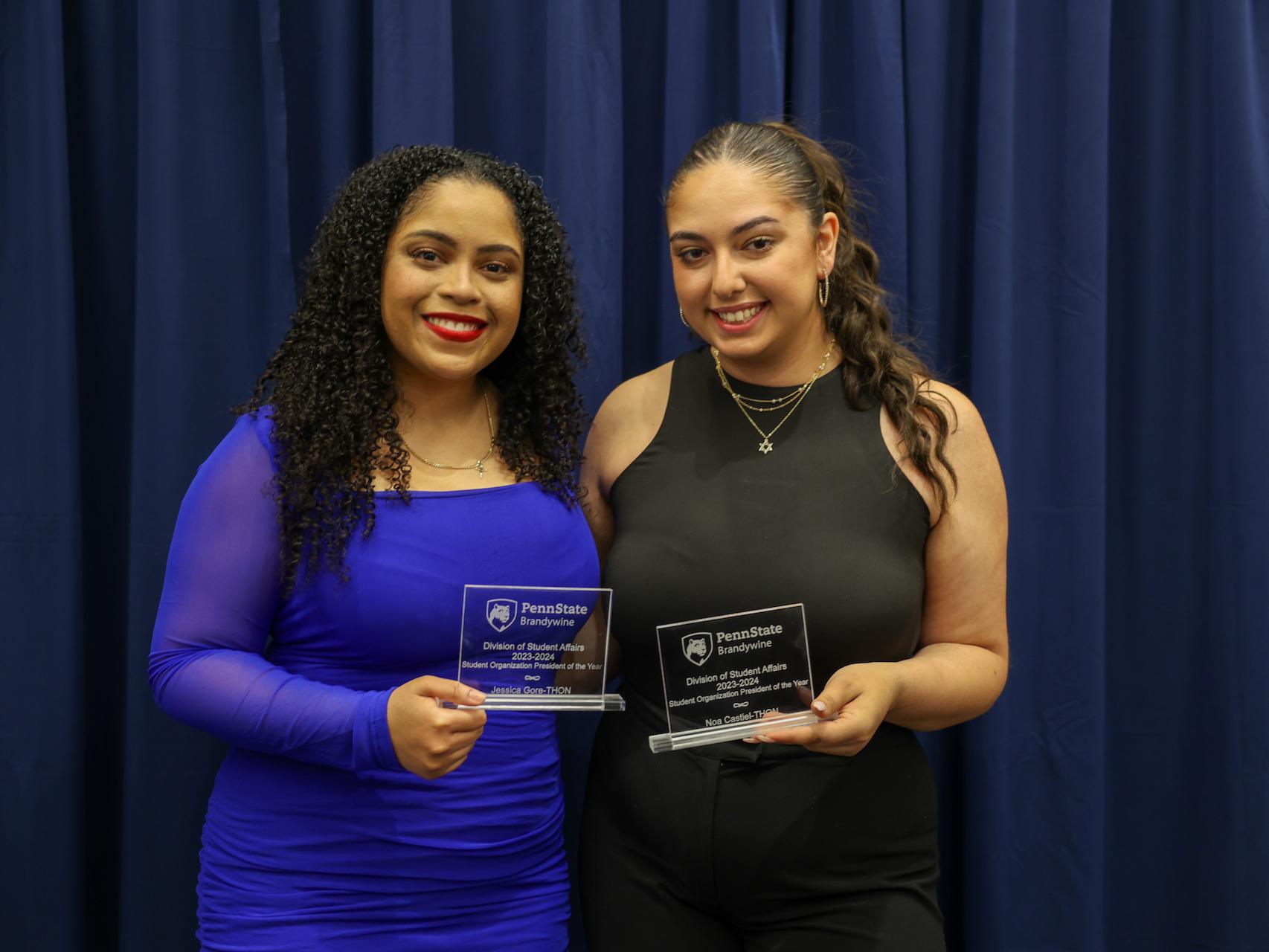 students holding awards