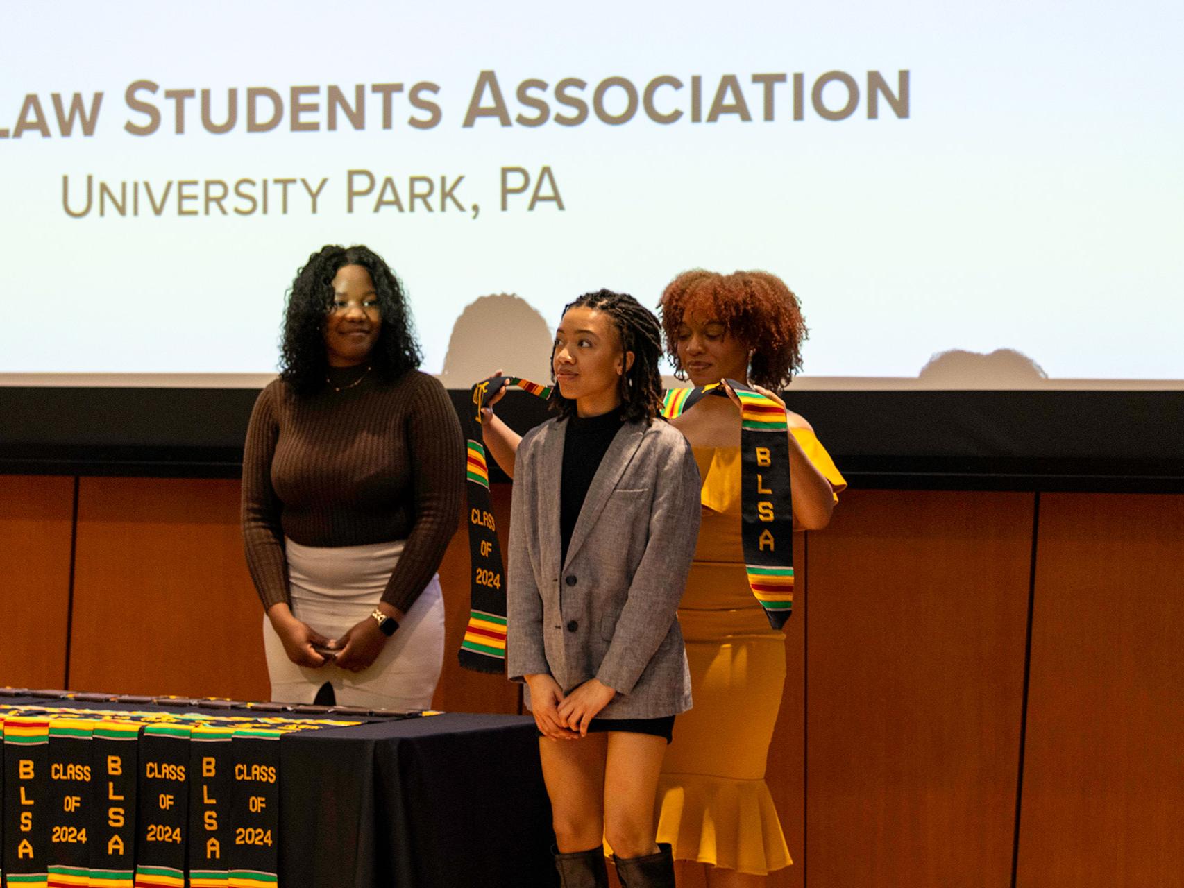 	Brooke Benjamin, part of the BLSA Class of 2024 at Penn State Law, receives the Kente cloth at the ceremony. 