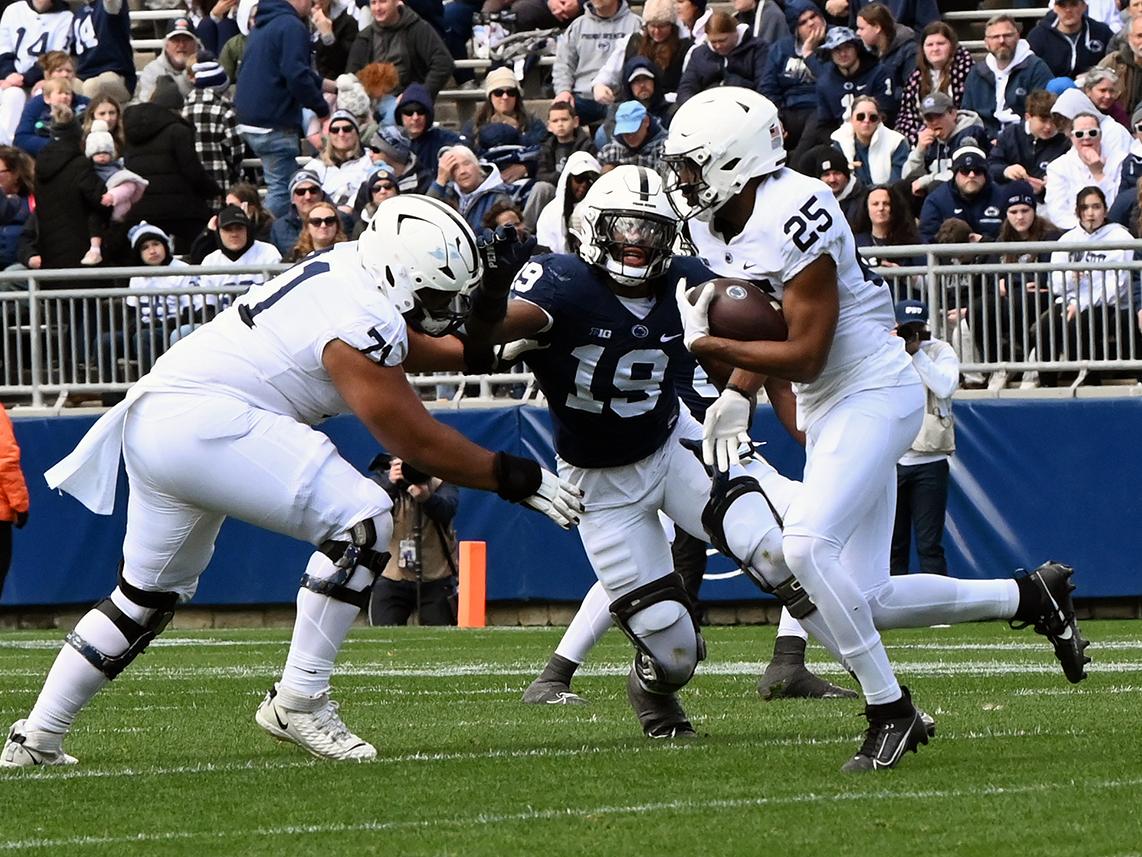 White team running back tries to run with ball