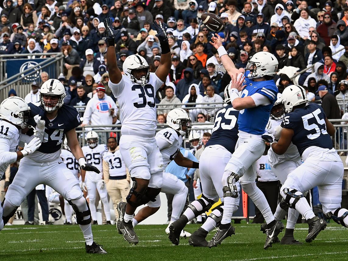 Quarterback tries to throw over defender