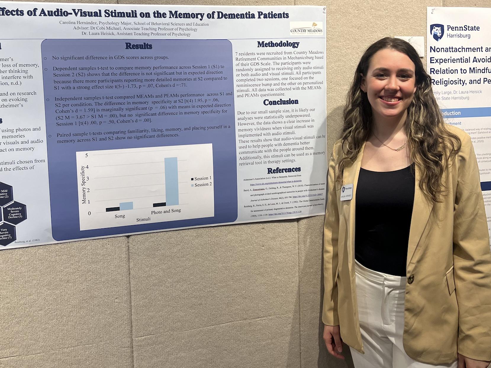 Carolina Hernandez stands with a research poster