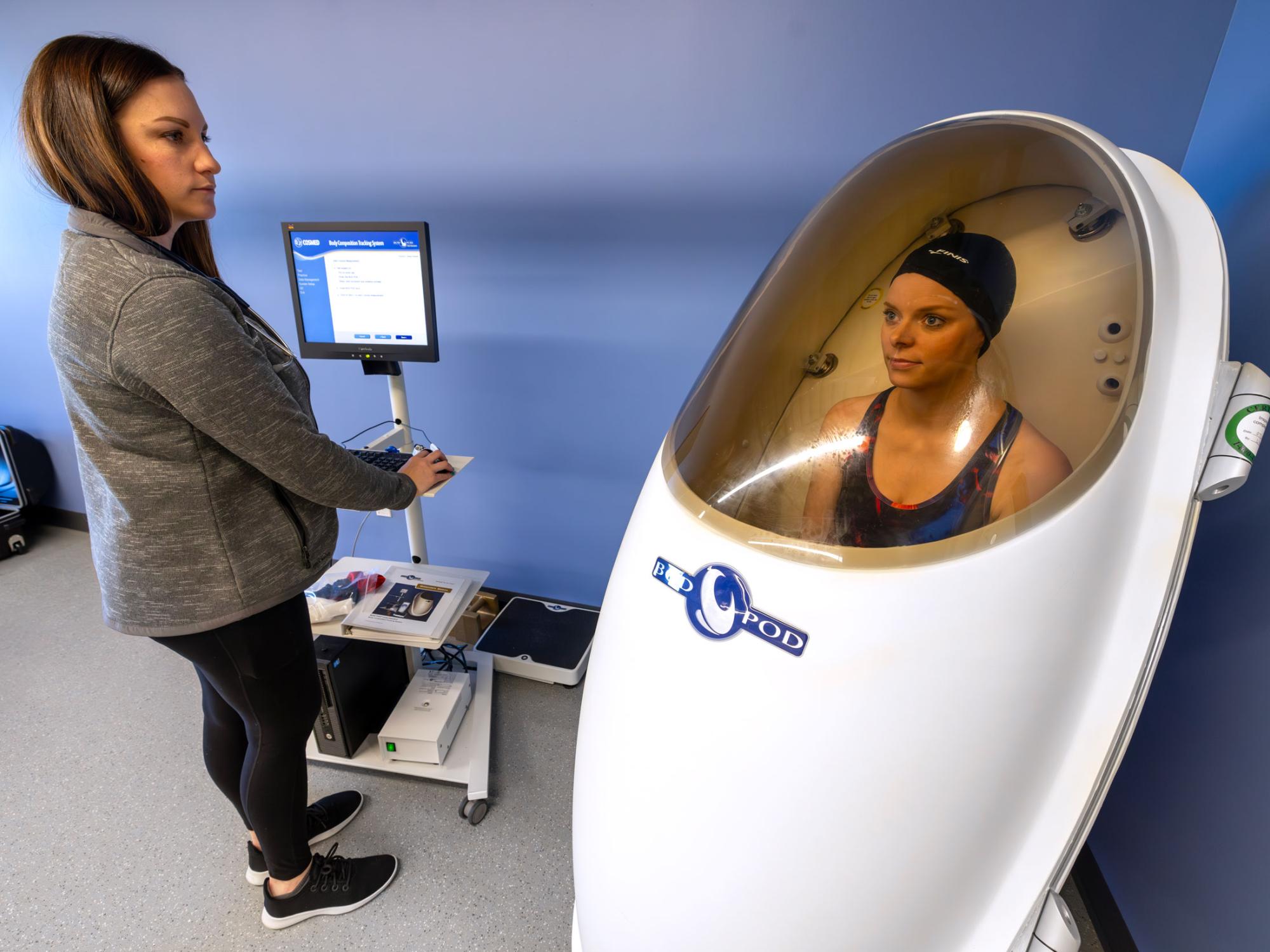ERC manager uses the BODPOD to measure body composition using Air Displacement Plethysmography (ADP)