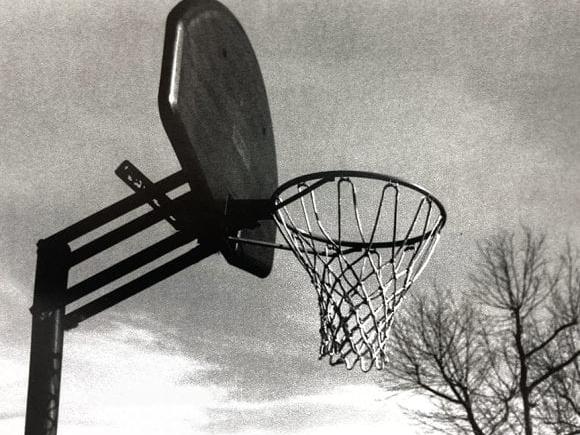 Black and white image of a basketball net